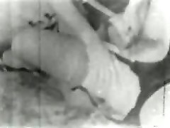Old-time vintage threesome porn with two babes sharing a strapon and a cock
